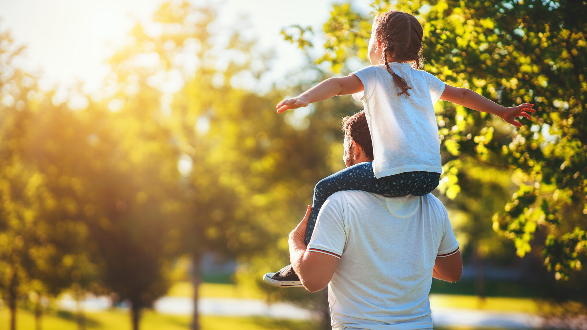 concept of father's day! happy family dad and child daughter back  in nature